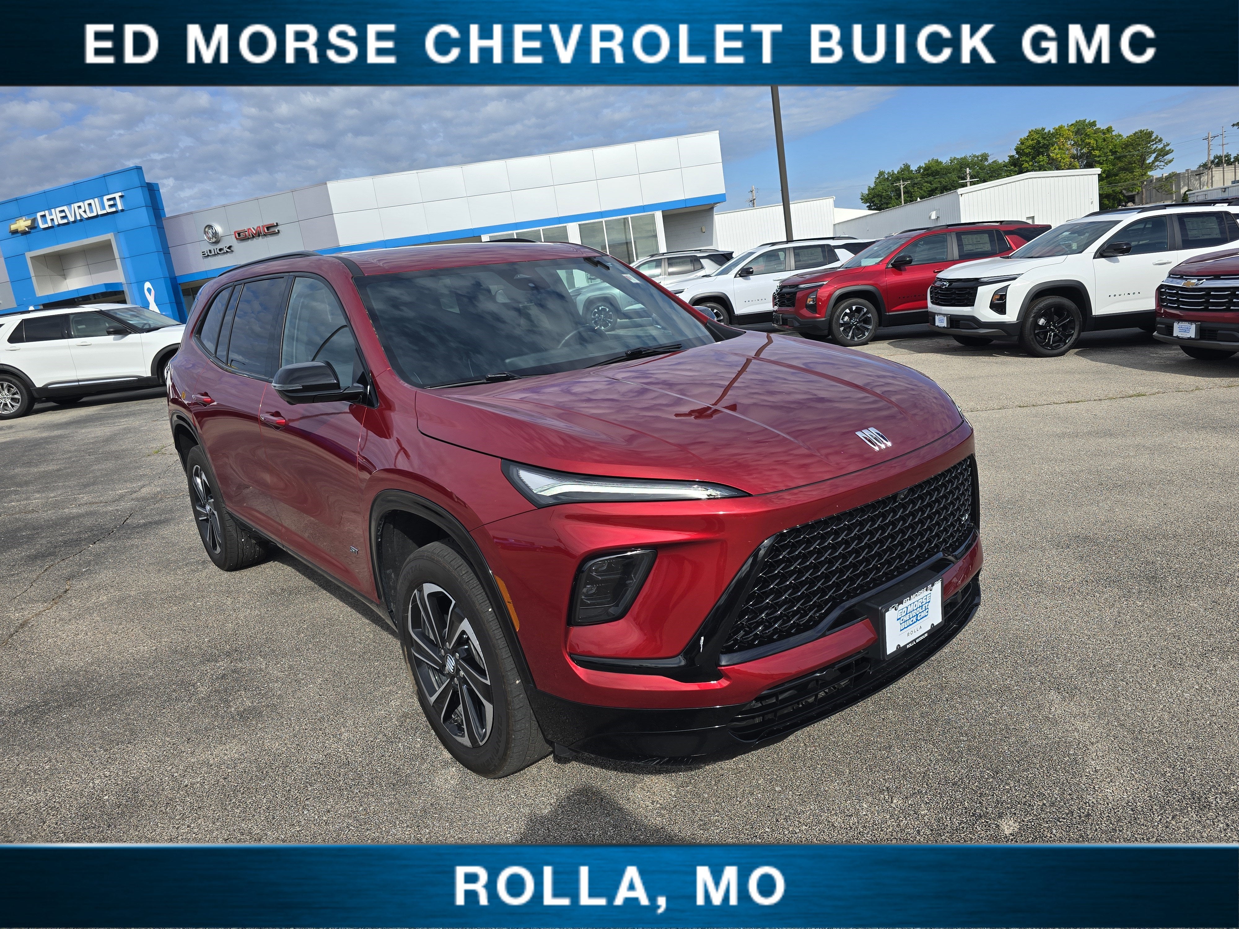 2025 Buick Enclave Sport Touring in Cherry Red Tintcoat — front three-quarter view